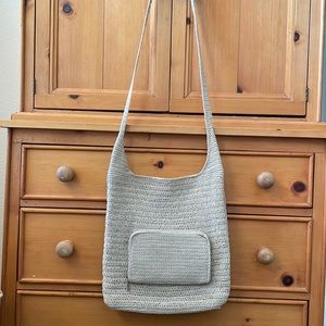Woven crossbody bag with external zip pocket wallet.